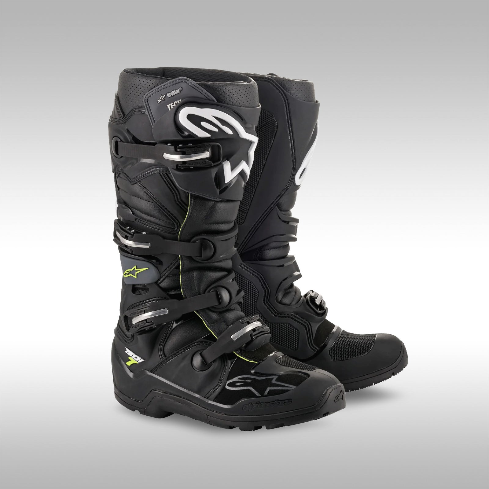 Pair of black motocross boots on a gray background