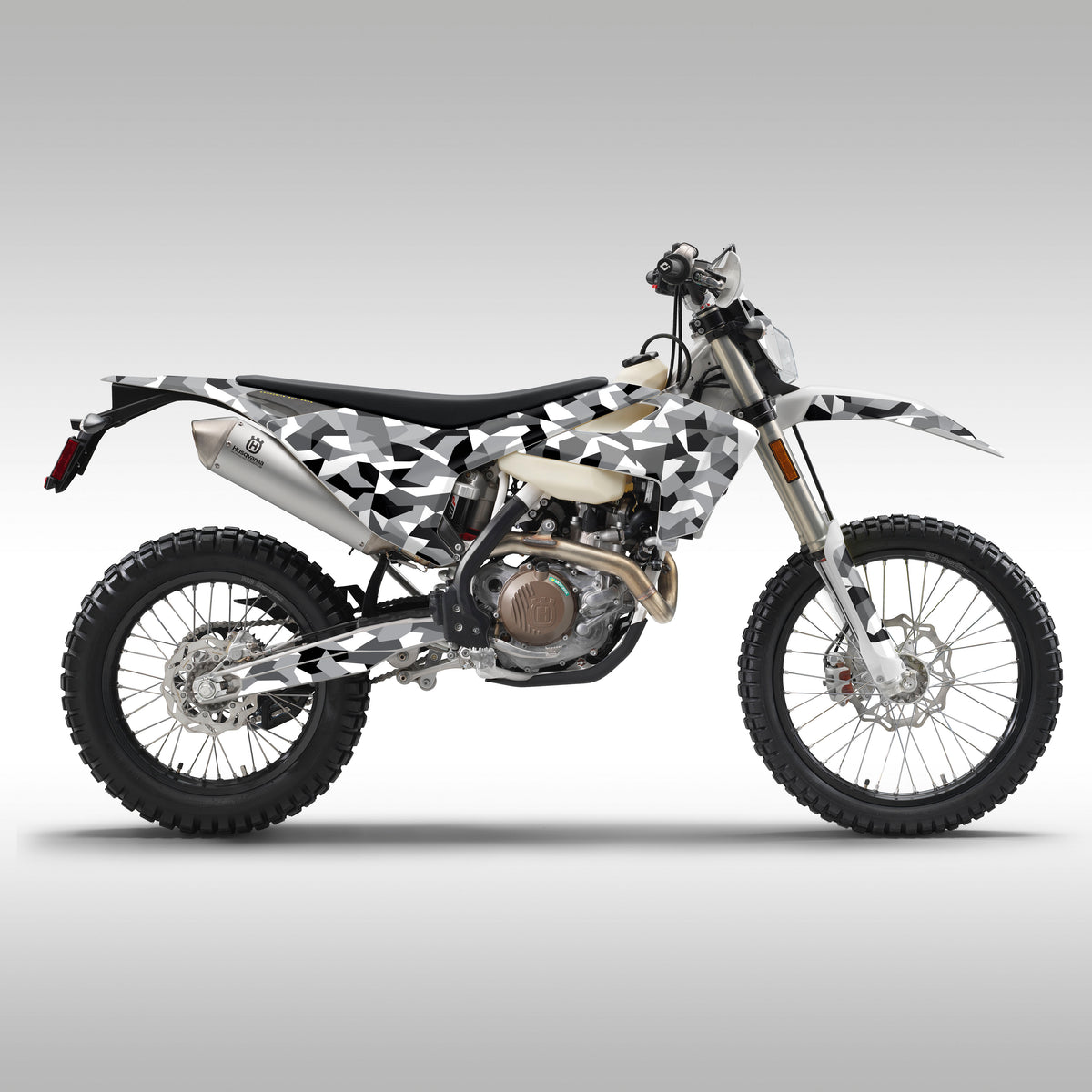 Side shot of a 2017 - 2019 Husqvarna FE / TE dualsport or enduro motorcycle with GEO Camo graphics installed.
