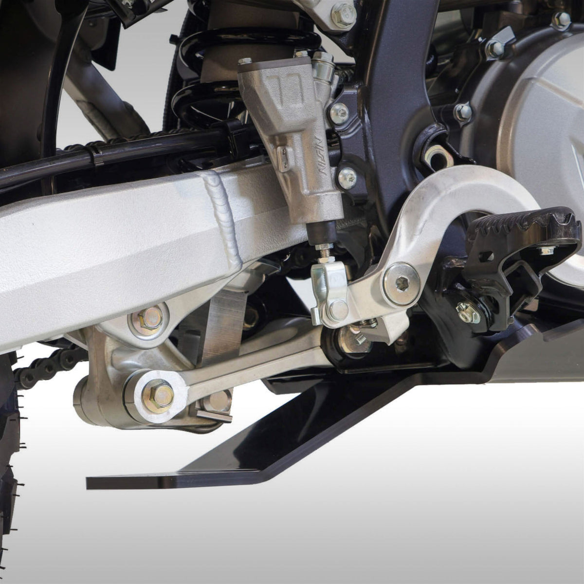 Black AXP Racing 8mm HDPE skid plate installed on a Suzuki DR-Z4S dual-sport motorcycle.