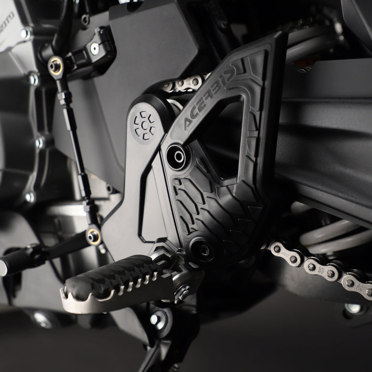 Black Acerbis X-Grip frame guards showing rubberized grip panels installed on a CFMOTO Ibex 450 adventure motorcycle.