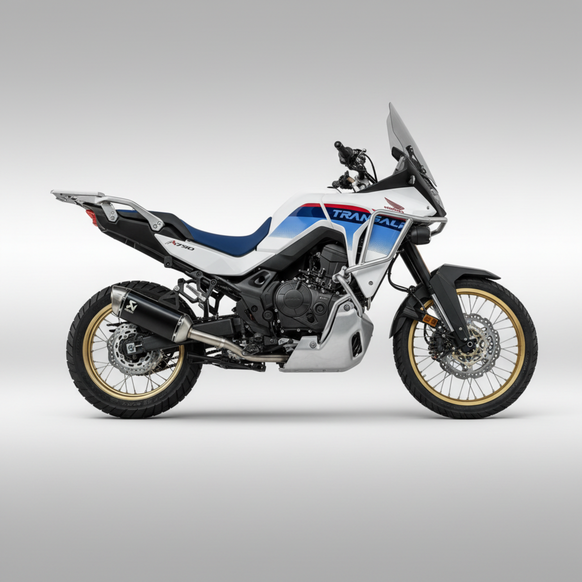 Honda Xl750 Transalp with Akrapovic header and muffler installed. Side profile on a light gray ackground.