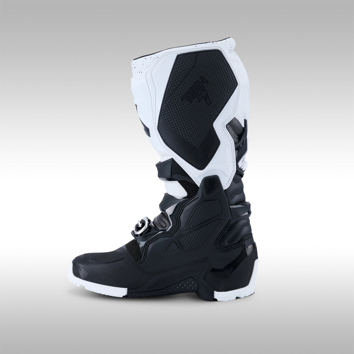 Single black and white Alpinestars Tech 7 Enduro offroad boot instep on a gray background at TMBR MOTO