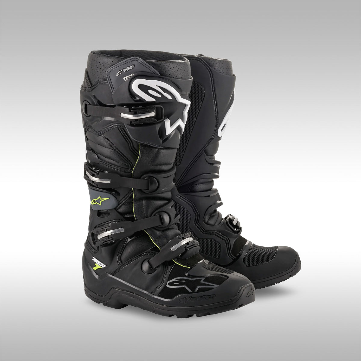 Pair of black motocross boots on a gray background