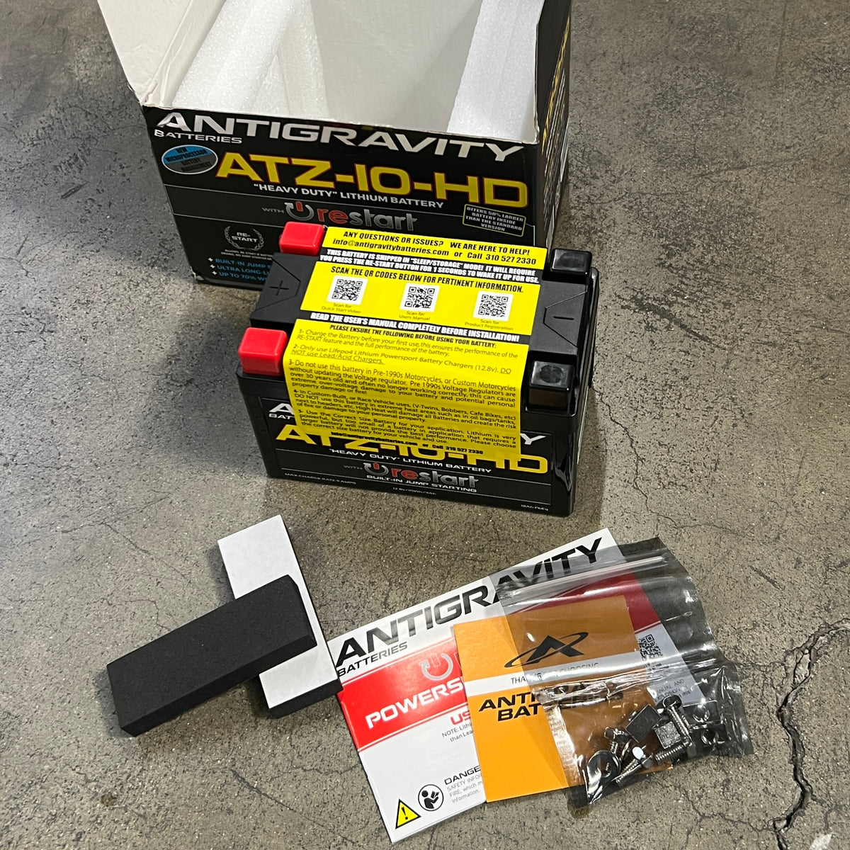 Antigravity ATZ-10-HD battery and packaging on a concrete surface