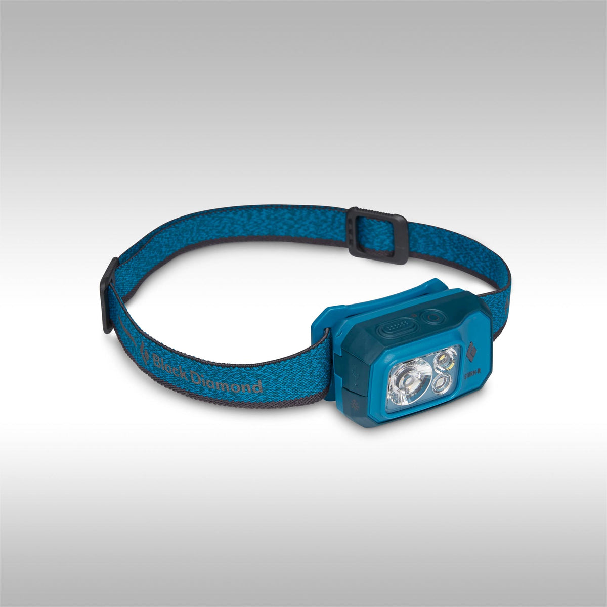 Blue headlamp with black strap on a gray background