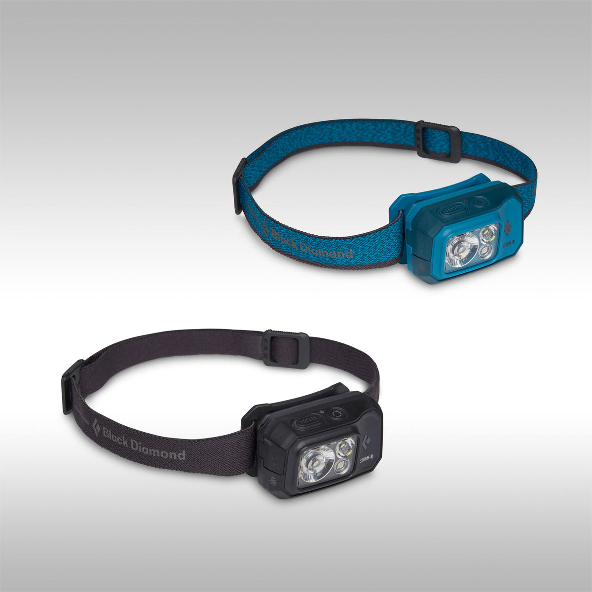 Two headlamps, one blue and one black, on a gray background