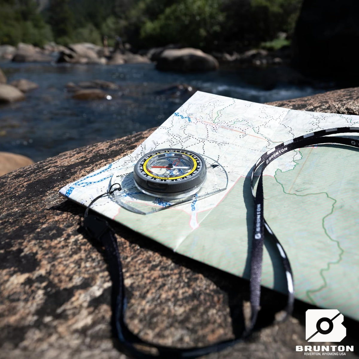 Brunton TruArc 3 baseplate compass showing the global needle, azimuth ring, and map scales.