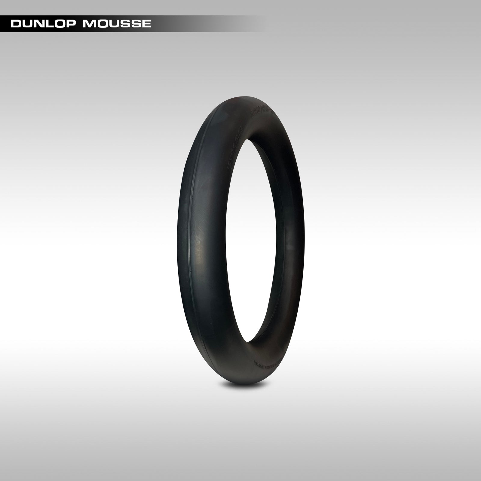 Black Dunlop Mousse tube on a gray background