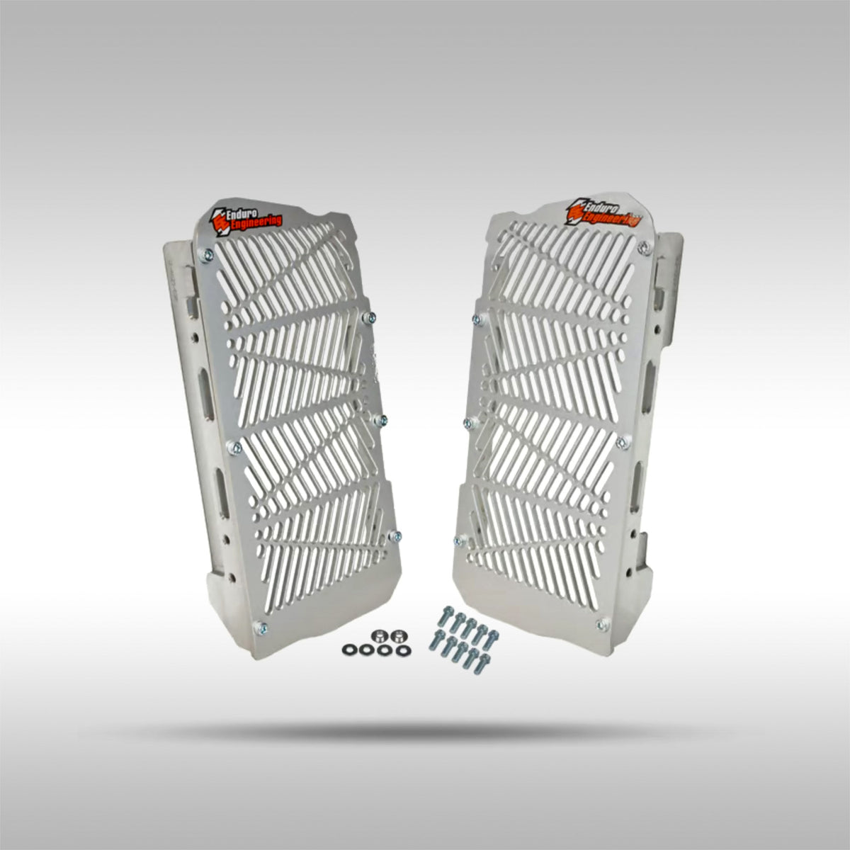 Pair of aluminum Enduro Engineering radiator guards with mounting hardware on a gray background