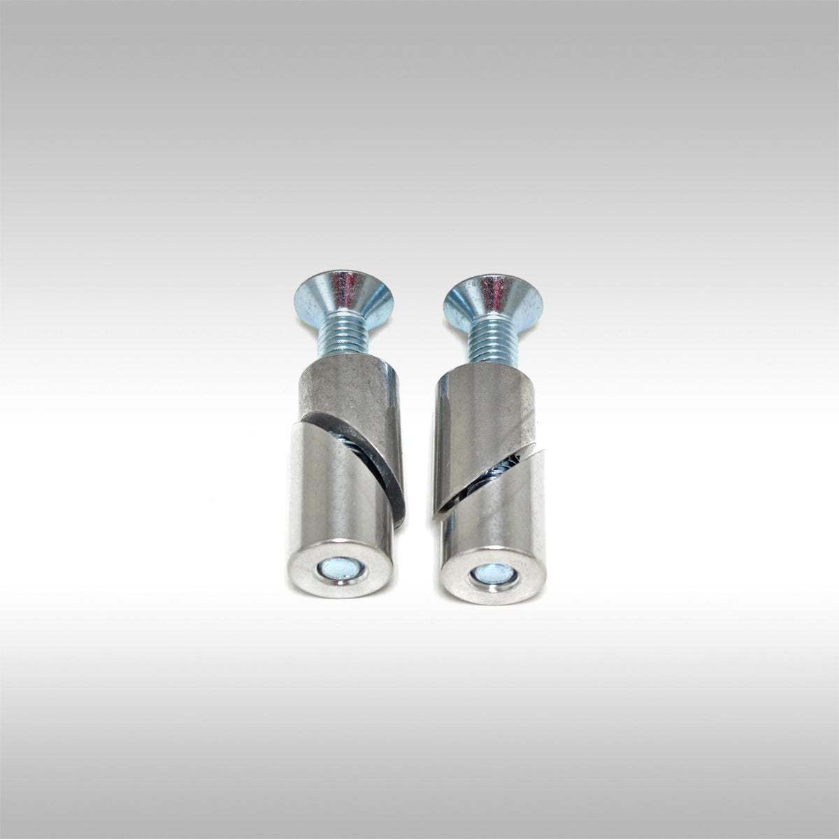Two aluminum taper locks with threaded ends and bolts on a light gray background