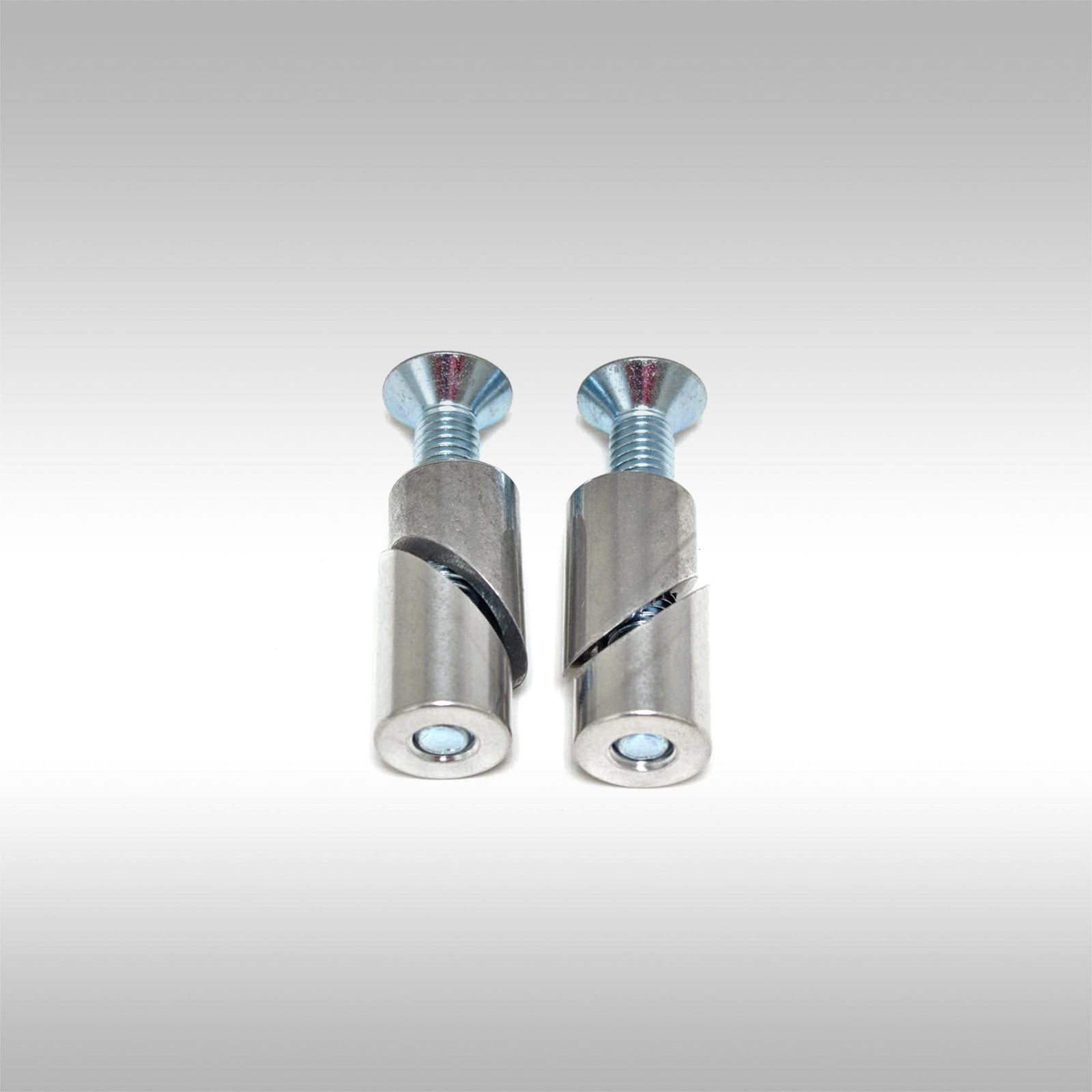 Two aluminum taper locks with threaded ends and bolts on a light gray background