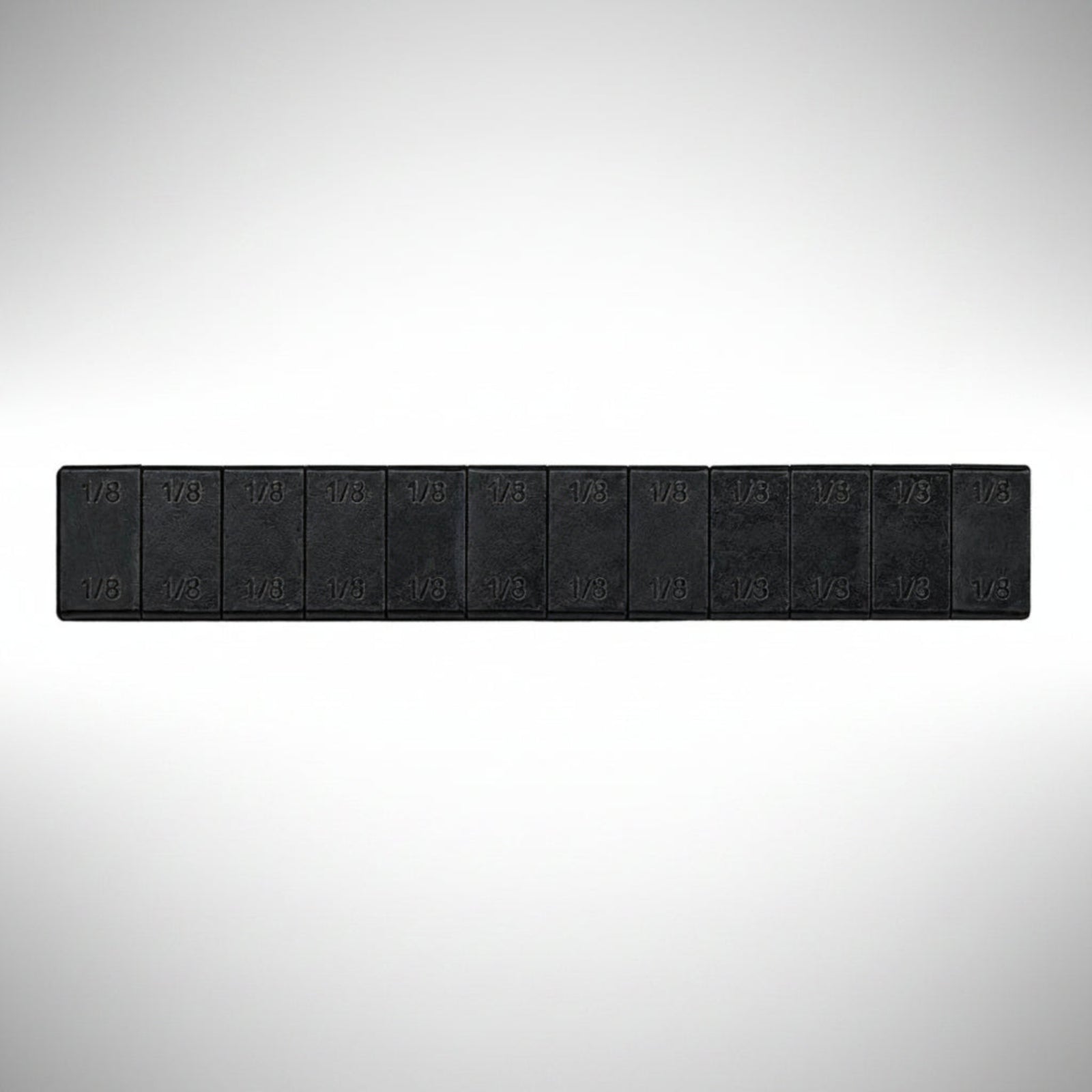 Fire Power adhesive stick-on wheel weight strips on a backing sheet.