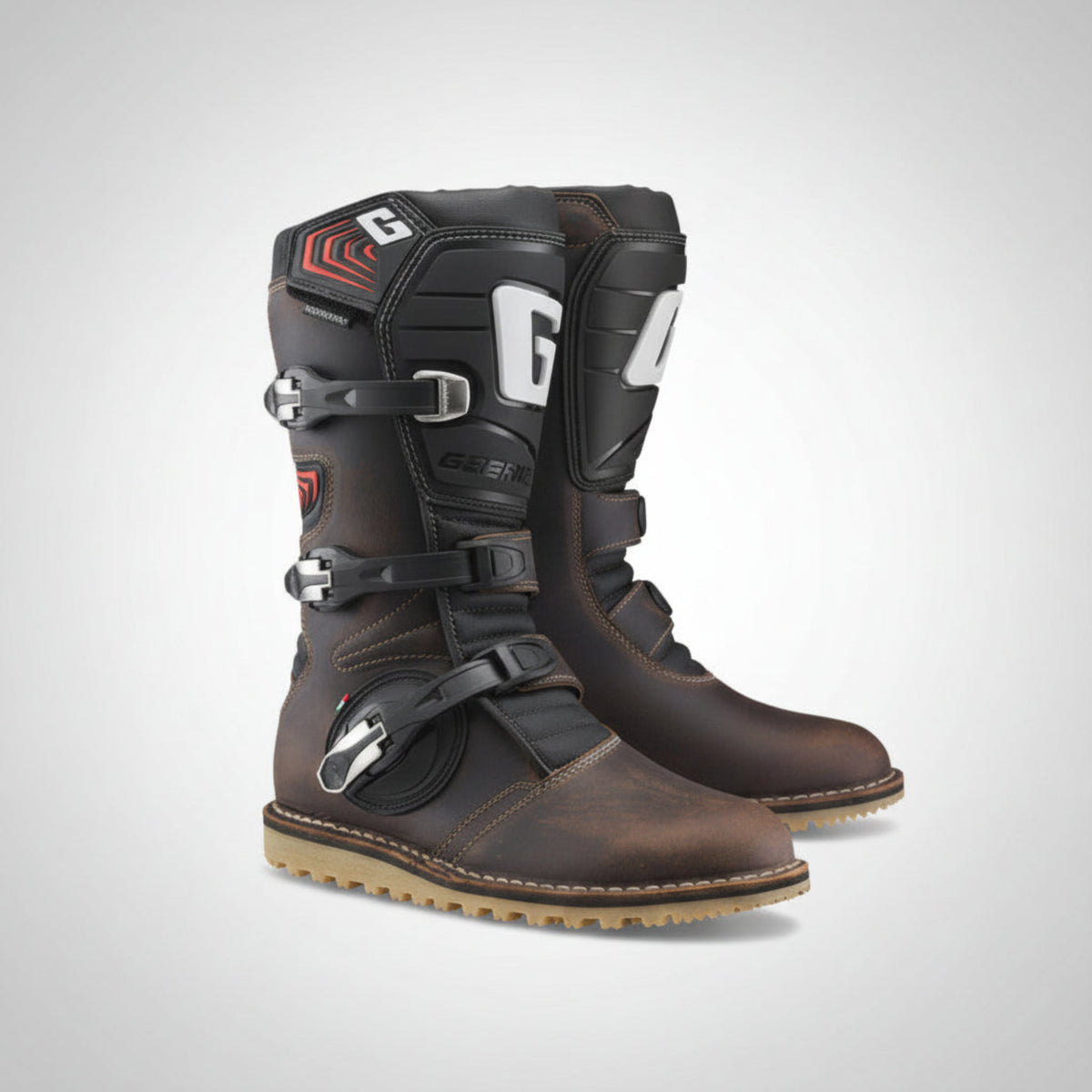 Pair of oiled brown leather Gaerne Balance motorcycle boots on a gray background