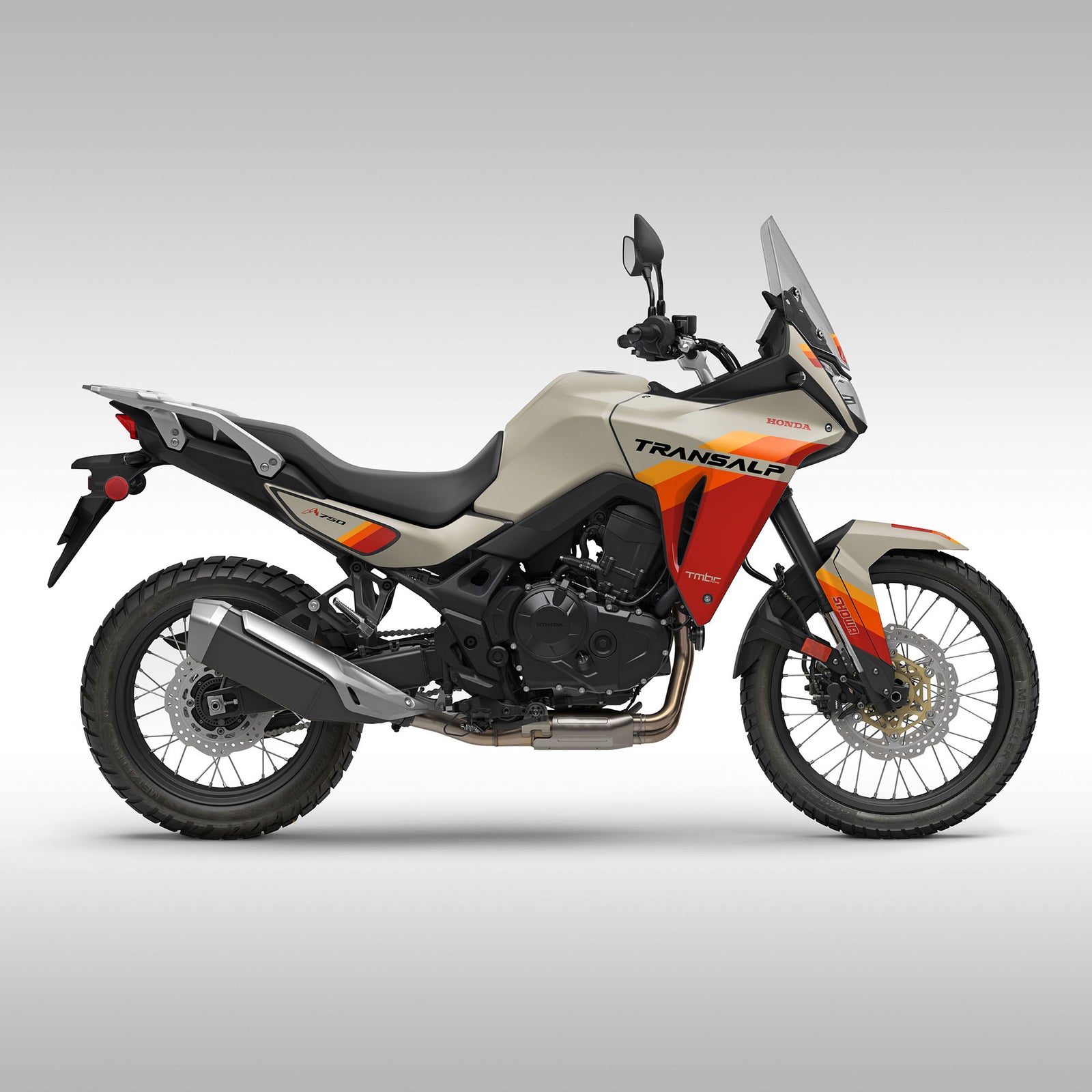 A 2024 Honda XL750 Transalp motorcycle with tan, black, and orange color scheme, showcasing the graphics kit with stripes.