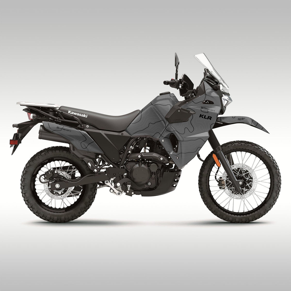 2022 + Kawasaki KLR650 side view. Topo graphics kit in matter gray. Topo lines are gray and black. Aftermarket motorcycle wrap or graphics kit.