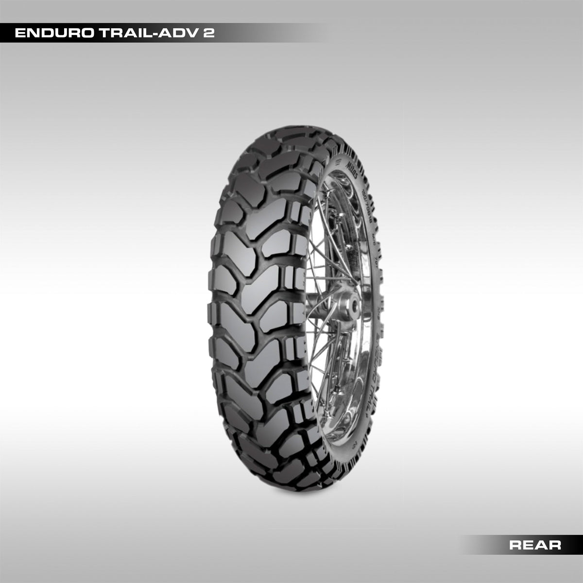 Motorcycle tire with tread pattern on a gray background, labeled 'Enduro Trail-Adv 2'.