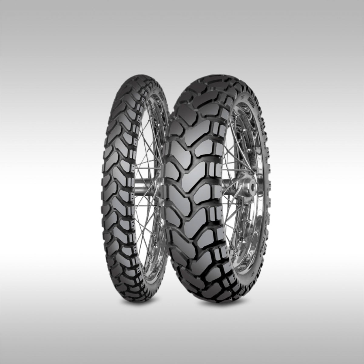 Pair of Mitas motorcycle tires with tread patterns on a light gray background