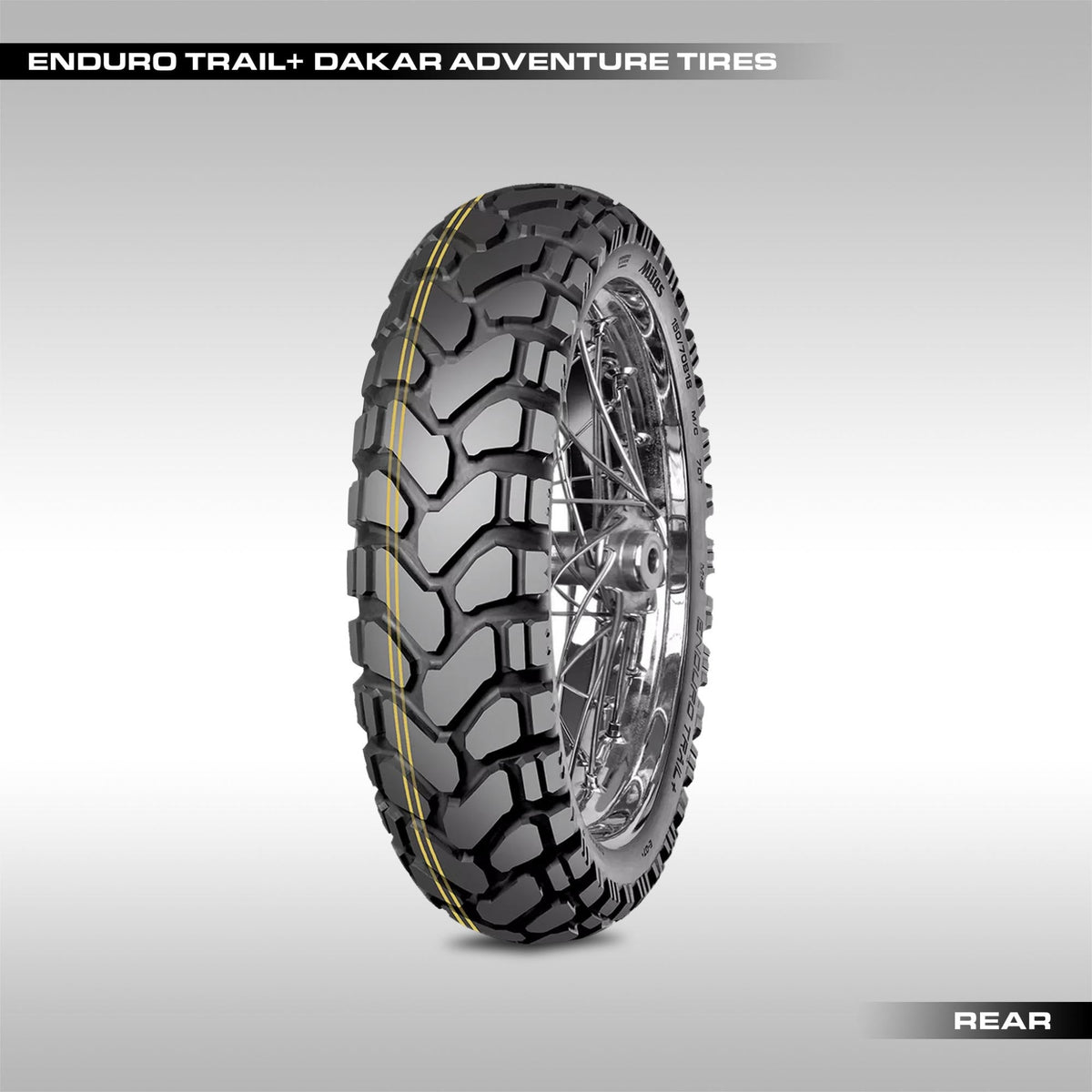 Mitas Enduro Trail+ Dakar adventure motorcycle tire showing the signature yellow stripe and large chevron block tread pattern.