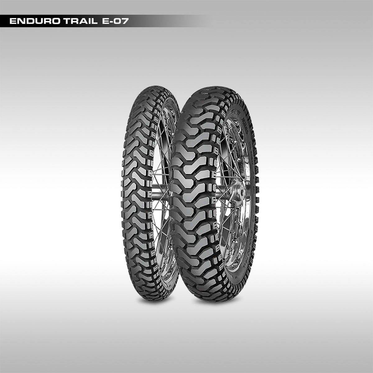 Two motorcycle tires with tread pattern on a gray background, labeled 'Mitas Enduro Trail E-07'.