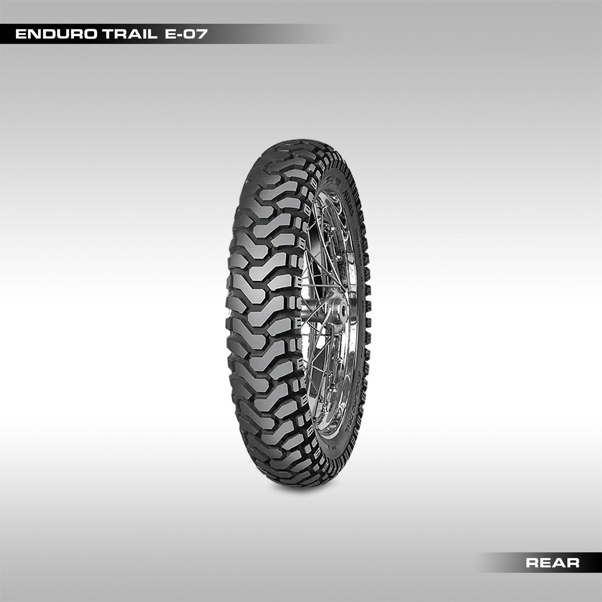 Rear Mitas Enduro Trail E-07 motorcycle tires with block chevron pattern tread, one in foreground and one slightly behind.