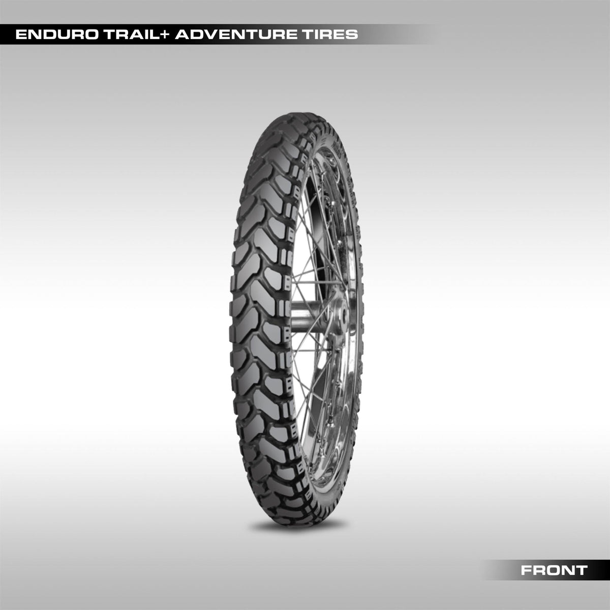 Mitas Enduro Trail+ adventure motorcycle tire showing the large chevron block tread pattern.