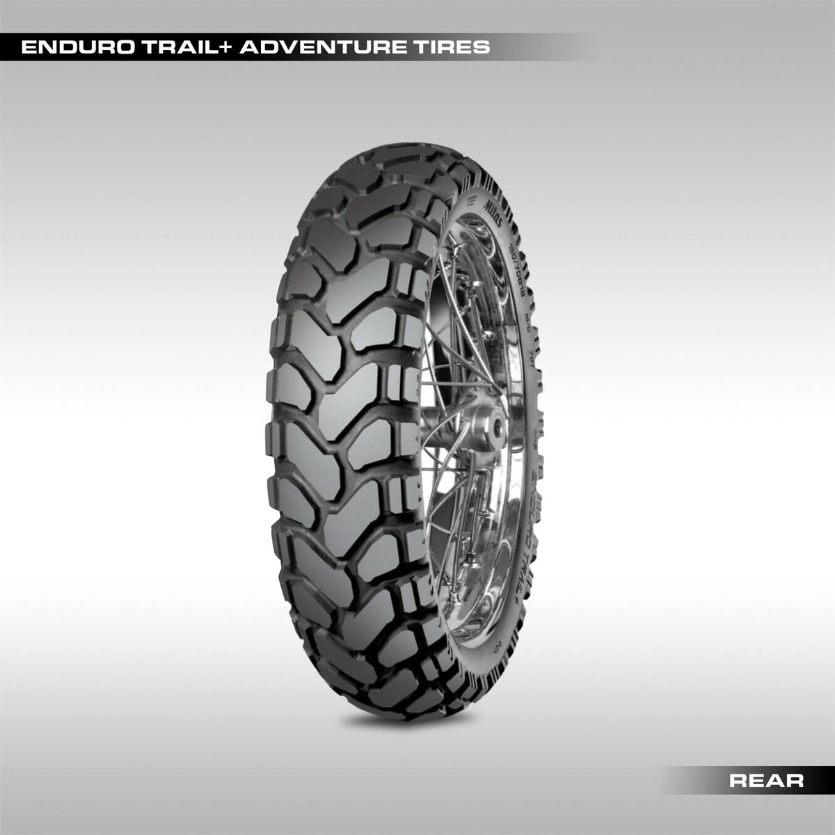 Mitas Enduro Trail+ adventure motorcycle tire showing the large chevron block tread pattern.