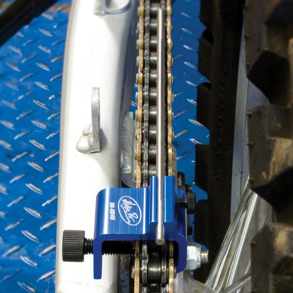 Blue Motion Pro chain alignment tool in use on a motorcycle drive train
