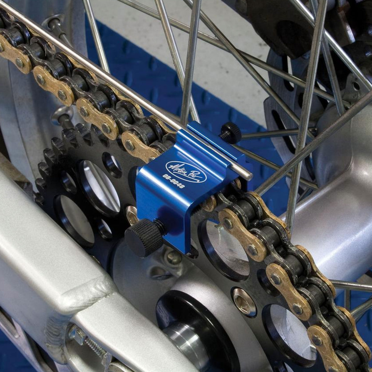 Blue Motion Pro chain alignment tool in use on a motorcycle drive train