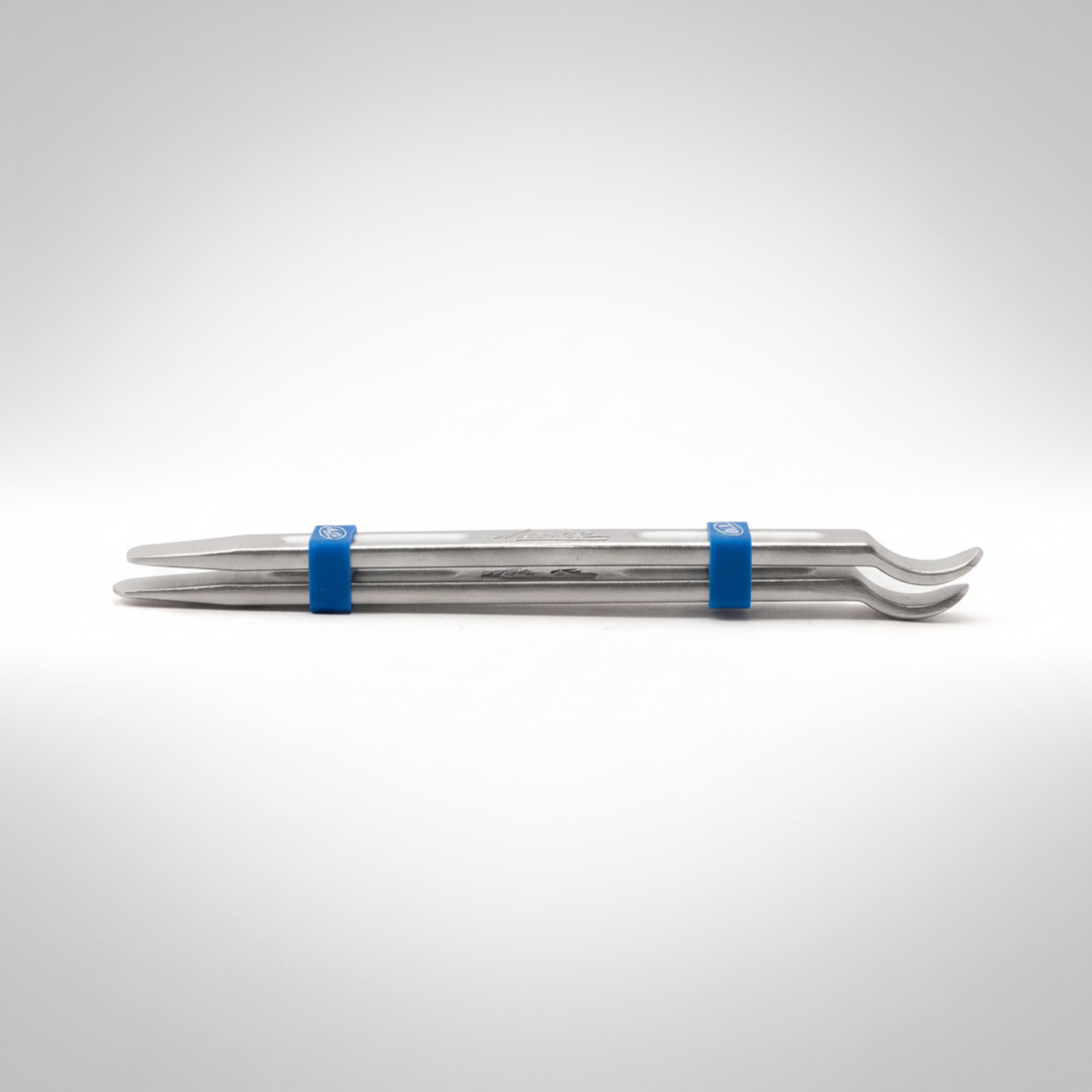 Pair of Motion Pro tire irons with blue keepers on a light gray background.