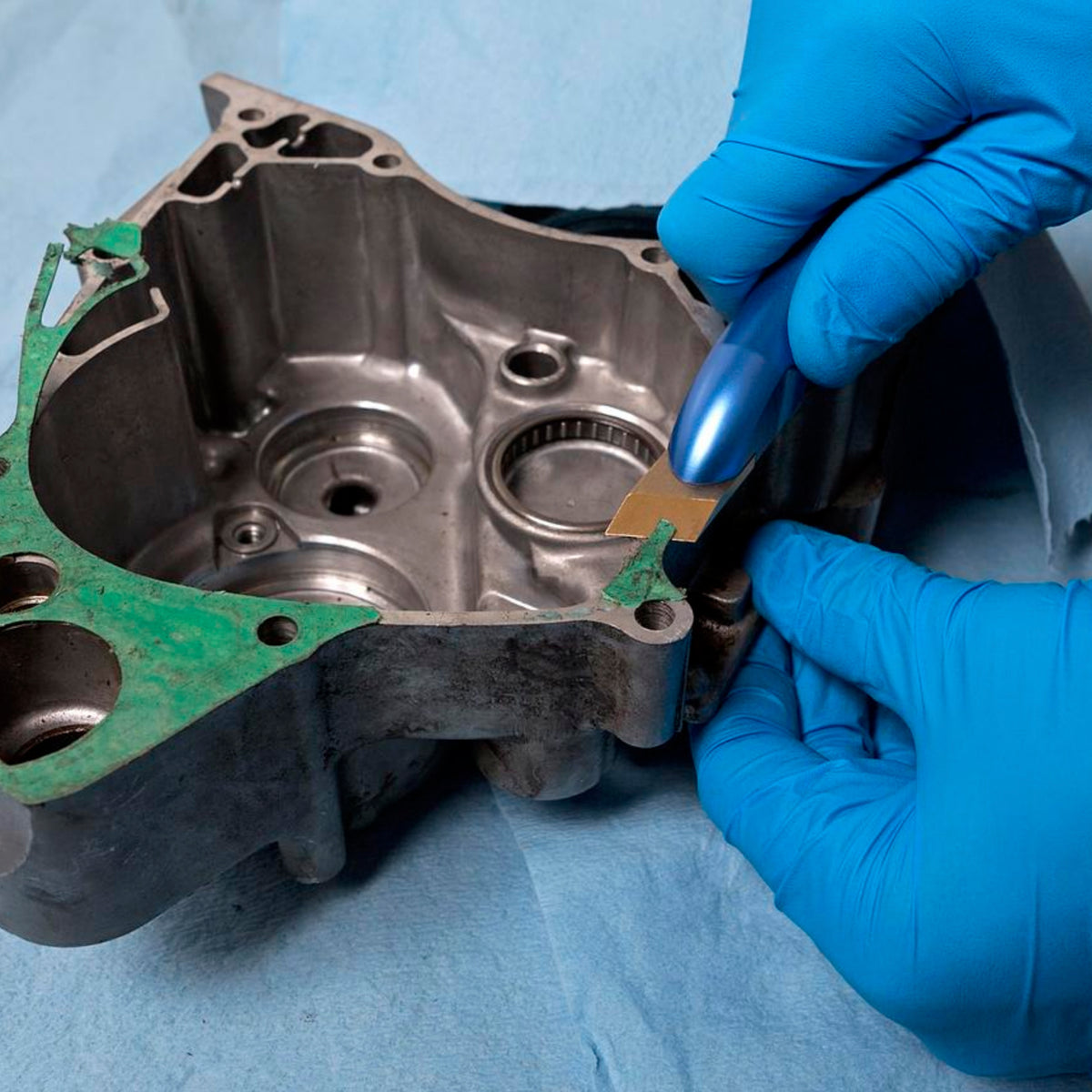 Motion Pro gasket scraper tool with the brass blade installed. Shows the scraper in use.