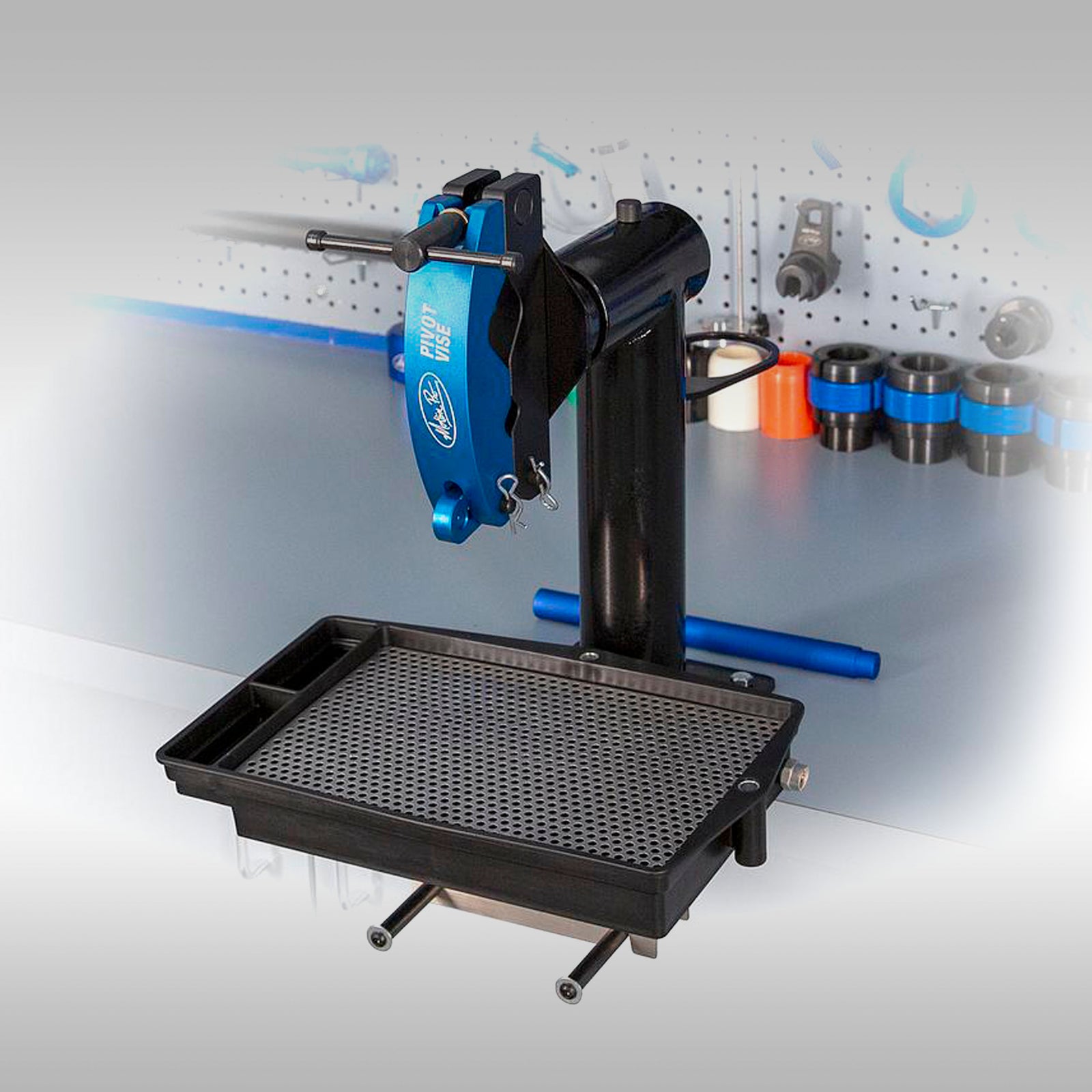 Motion Pro Pivot Suspension Vise for motorcycle suspension service, mounted on a bench with a blue and black color scheme.