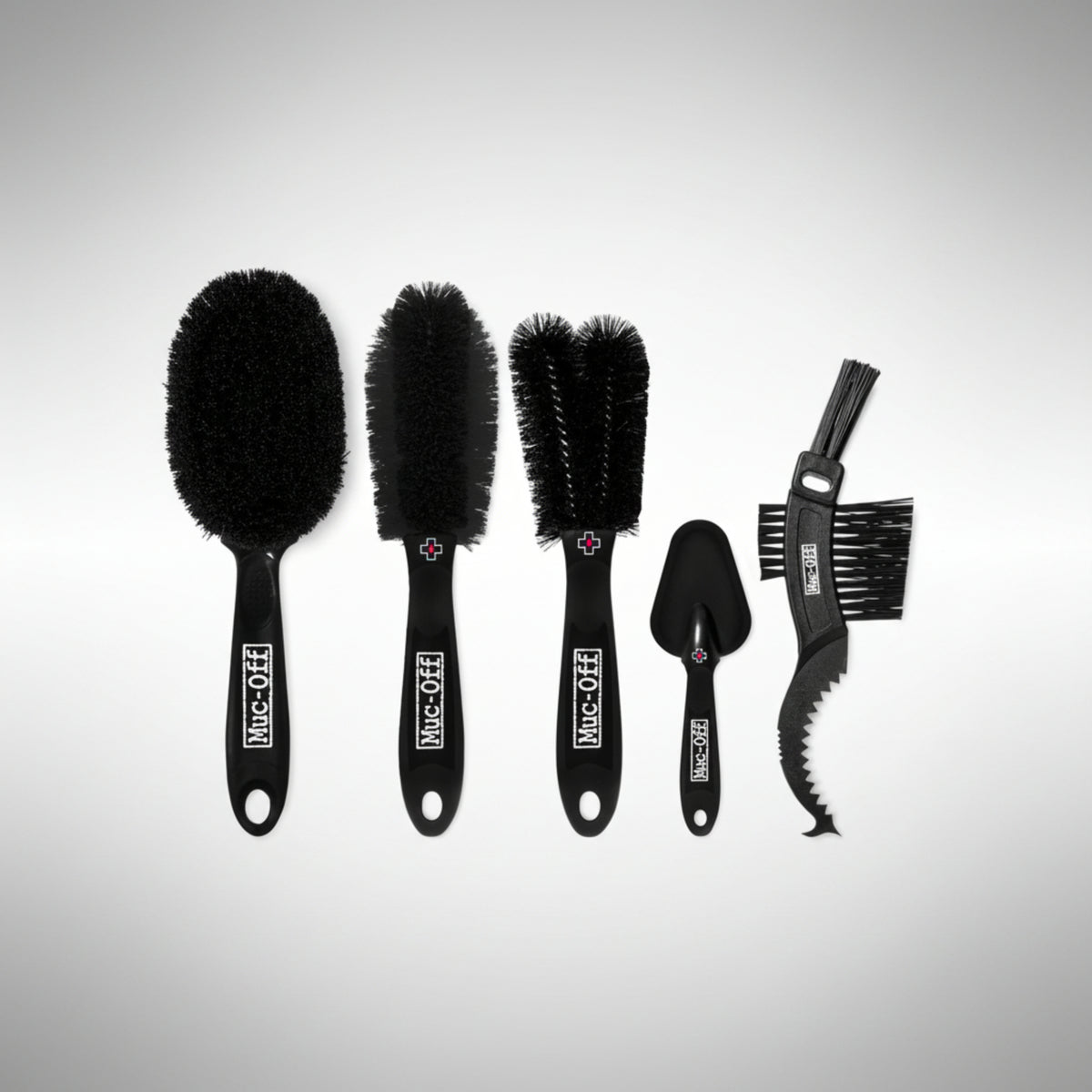 Muc-Off Premium 5-Brush Kit showing various detailing brushes for motorcycle cleaning.