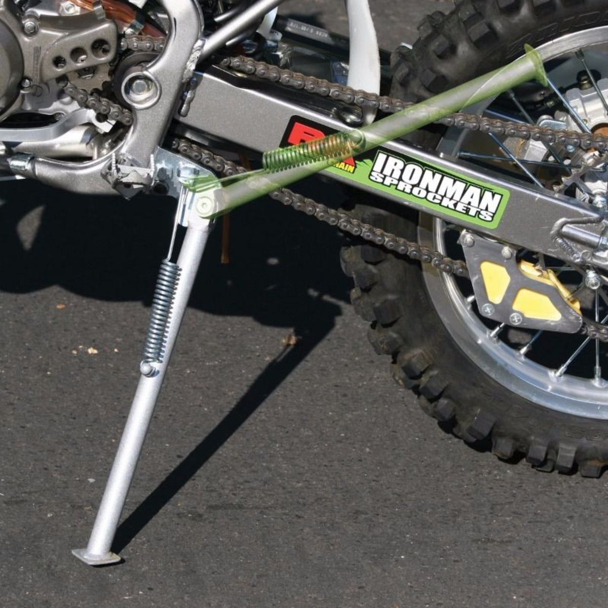 Close up of a silver chromoly kickstand from Steahly Offroad installed on the Kawasaki KX85 Small Wheel dirtbike.