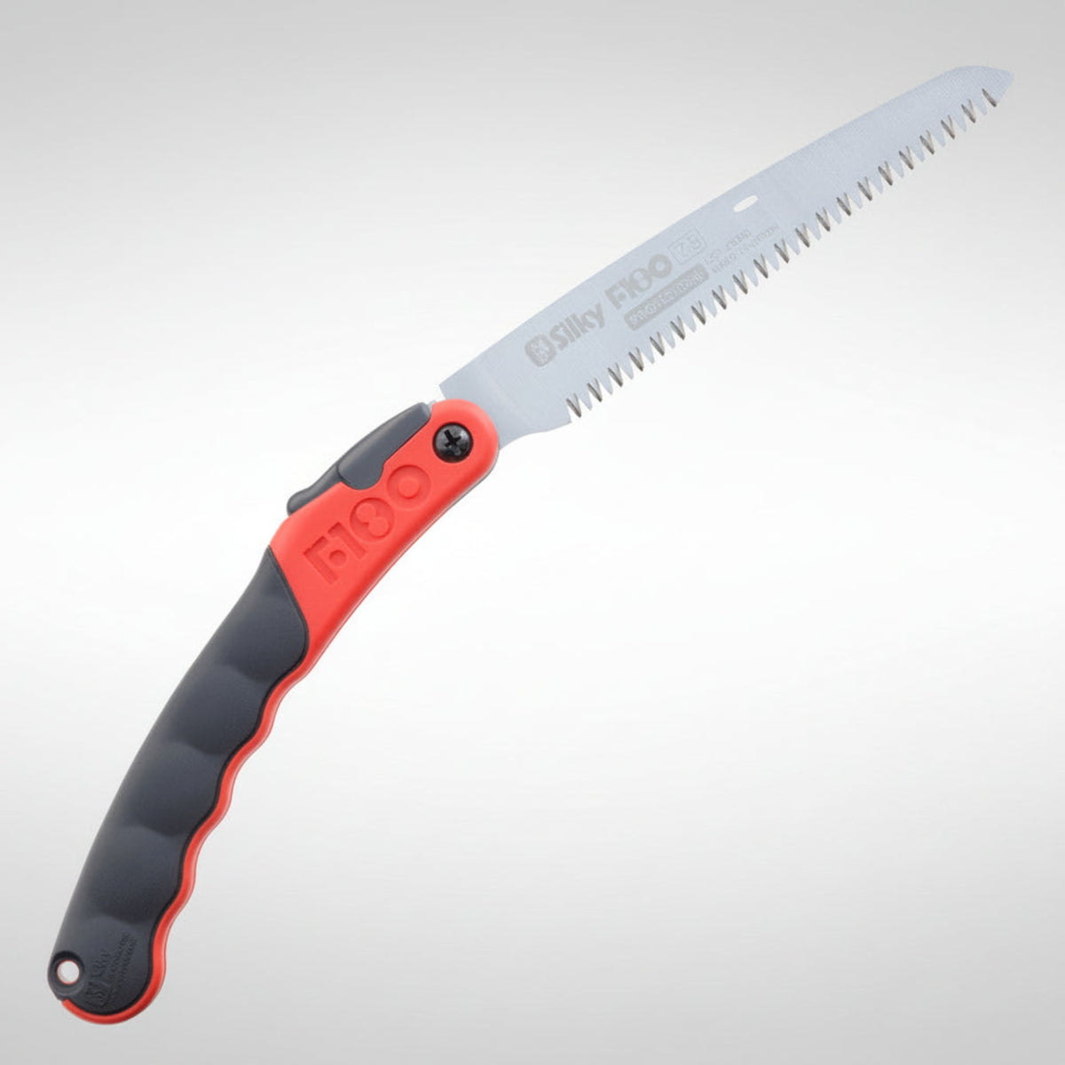 Folding saw with red and black handle on a light gray background