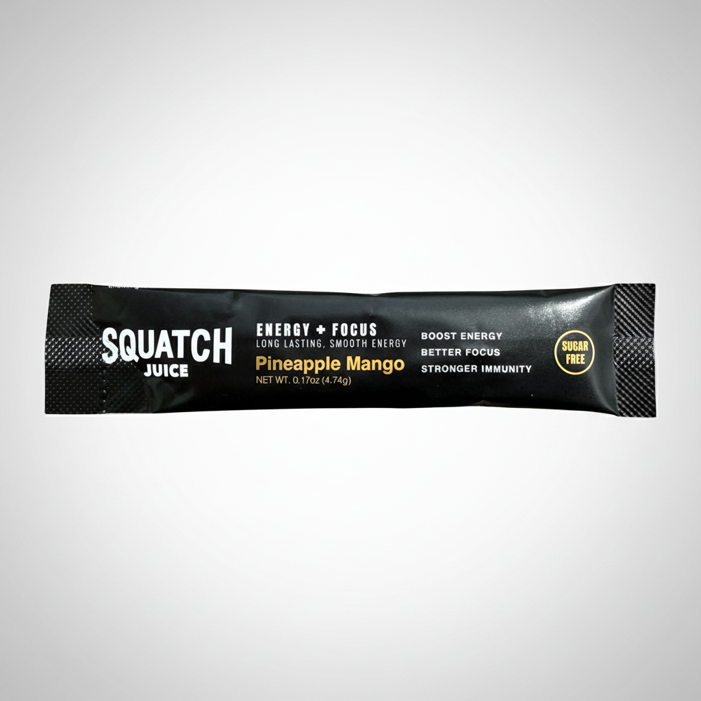A single-serve packet of Squatch Juice in Pineapple Mango flavor, shown horizontally against a light gray gradient background. The packet is black with white and yellow text, and a small gold 'Sugar Free' seal on the right side.
