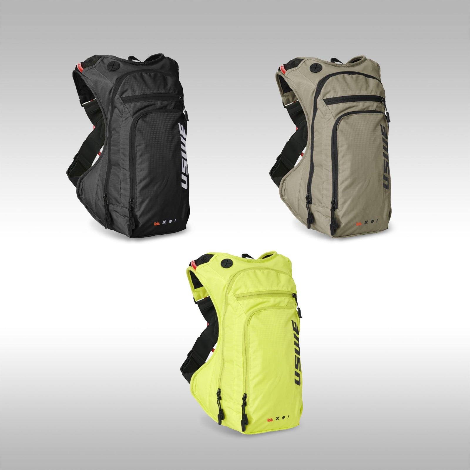 Three USWE backpacks in black, beige, and yellow on a gray background