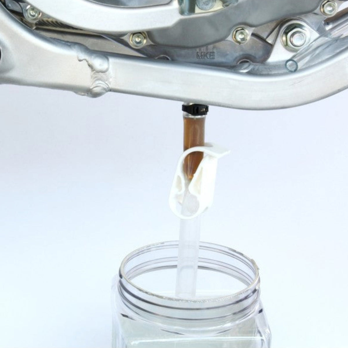 Works Connection 24-100 EZ Oil Drain tool featuring an aluminum adapter, silicone hose, and flow clamp.