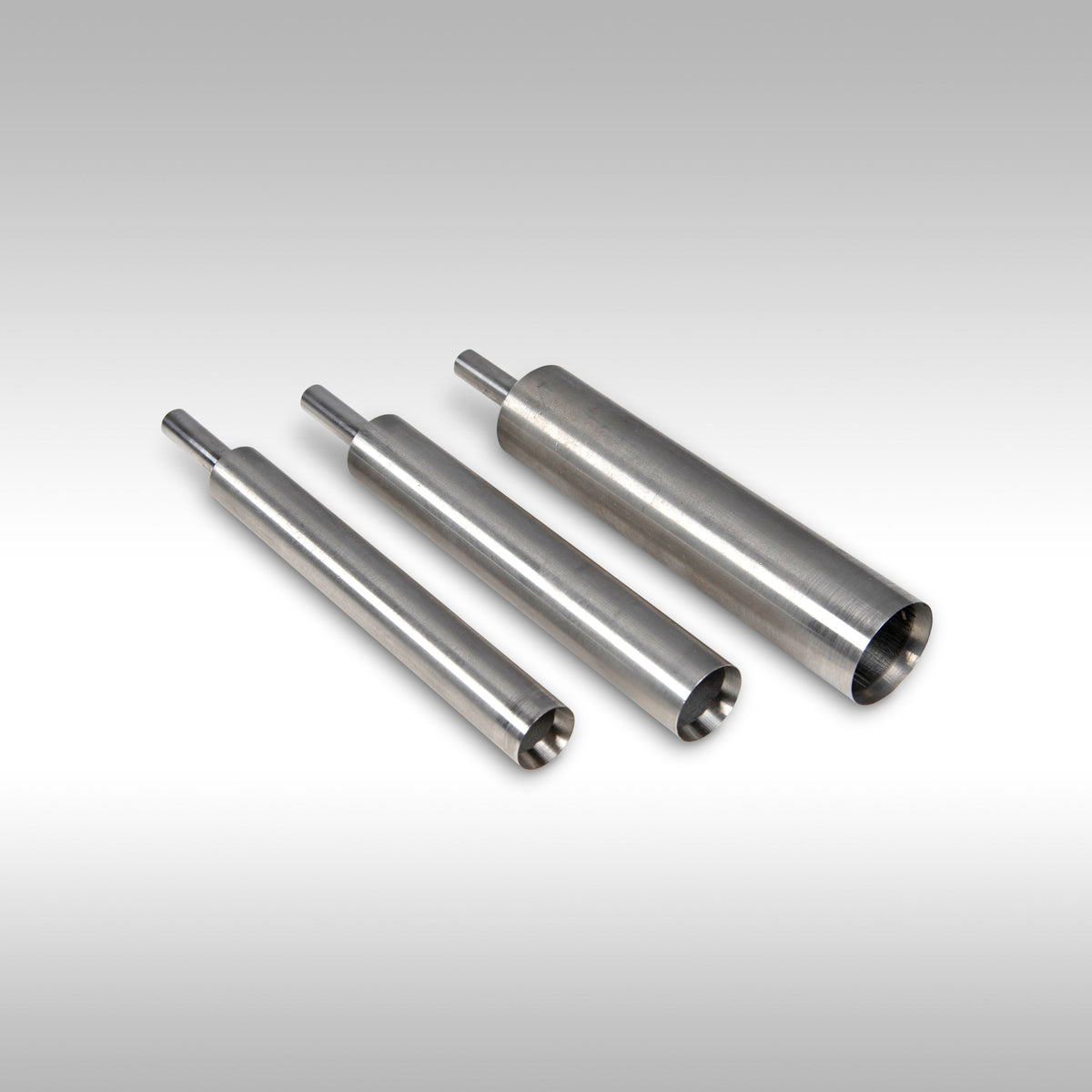 Three metallic cylindrical components on a gradient background