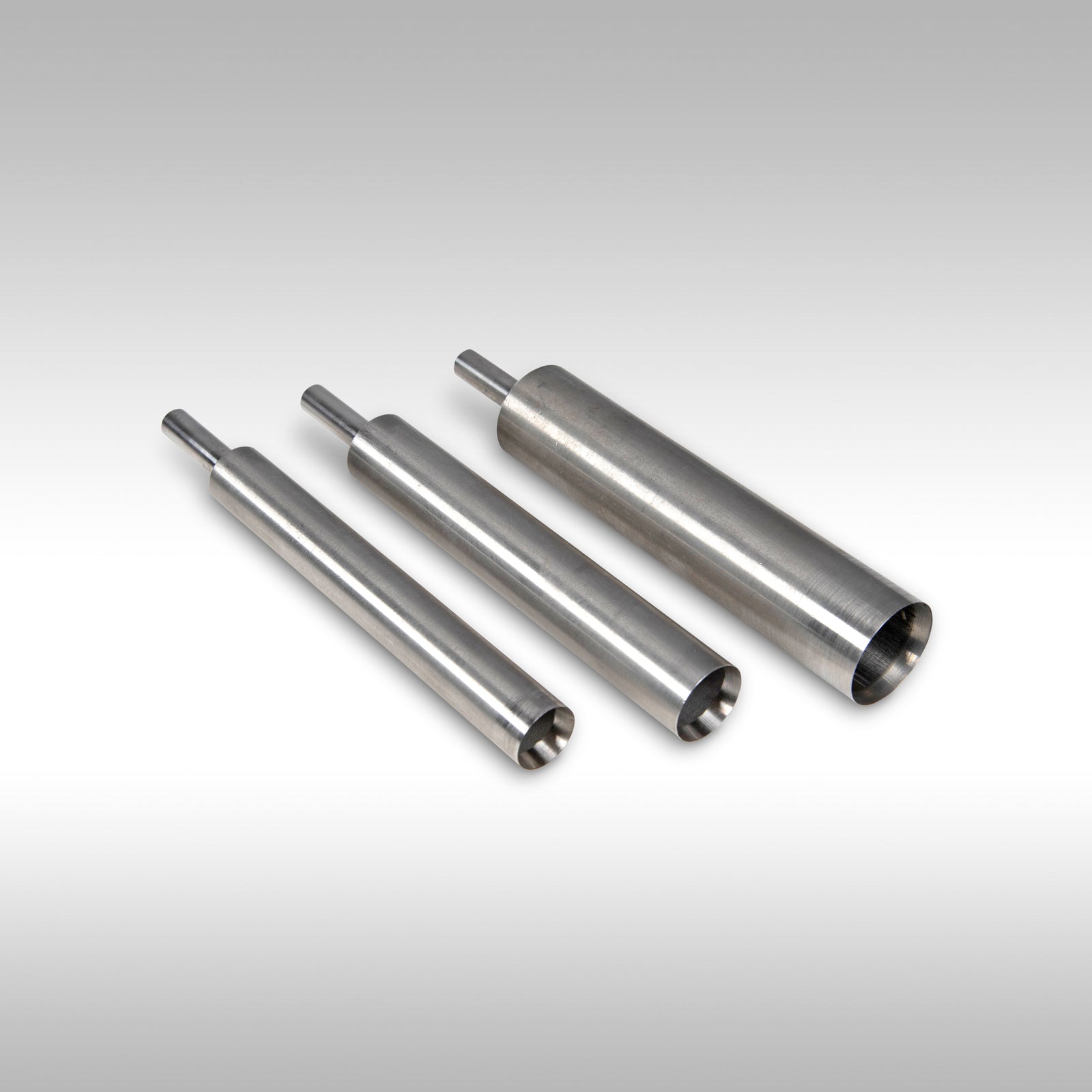 Three metallic cylindrical components on a gradient background