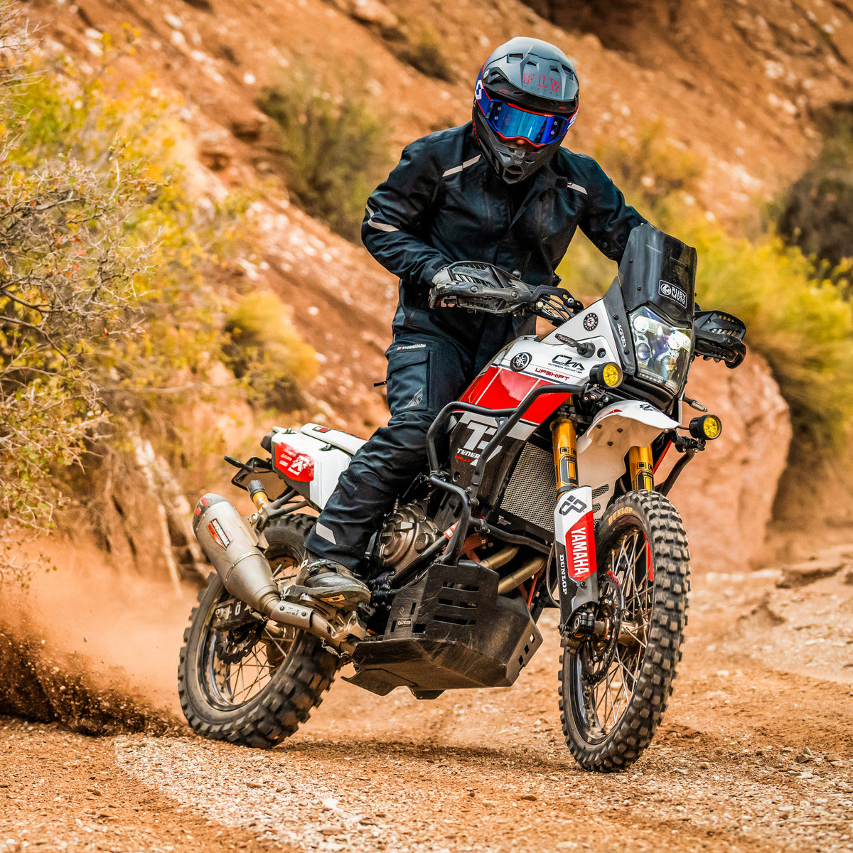 Motorcyclist riding on a dirt road with a Yamaha motorcycle with a Yoshimura RS12 installed.