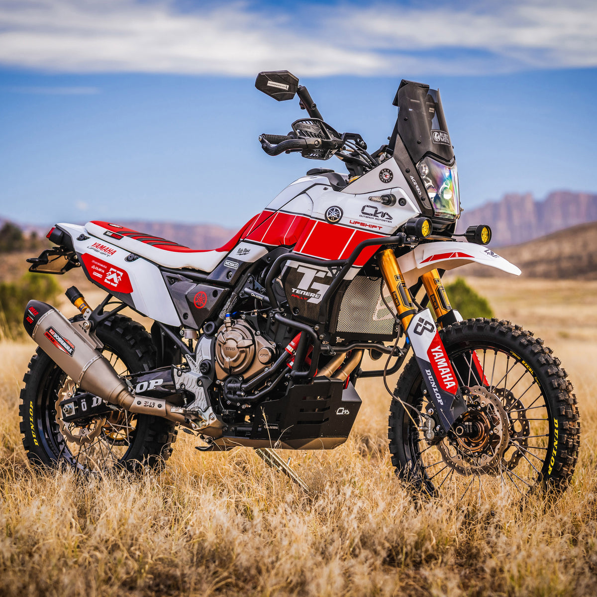 Motorcycle on a dirt road with mountains in the background with a Yoshimura RS-12 exhaust system installed.