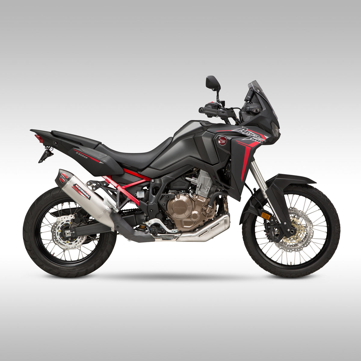 Yoshimura RS-12 slip-on exhaust pipe on black Honda CRF1100 Africa Twin on a gray background