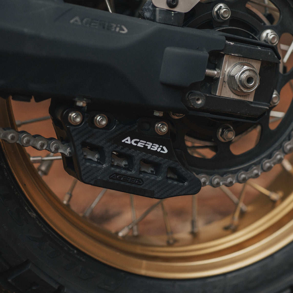 Acerbis brand motorcycle chain guide kit for the Yamaha Tenere 700, installed on a T7. Black version shown.
