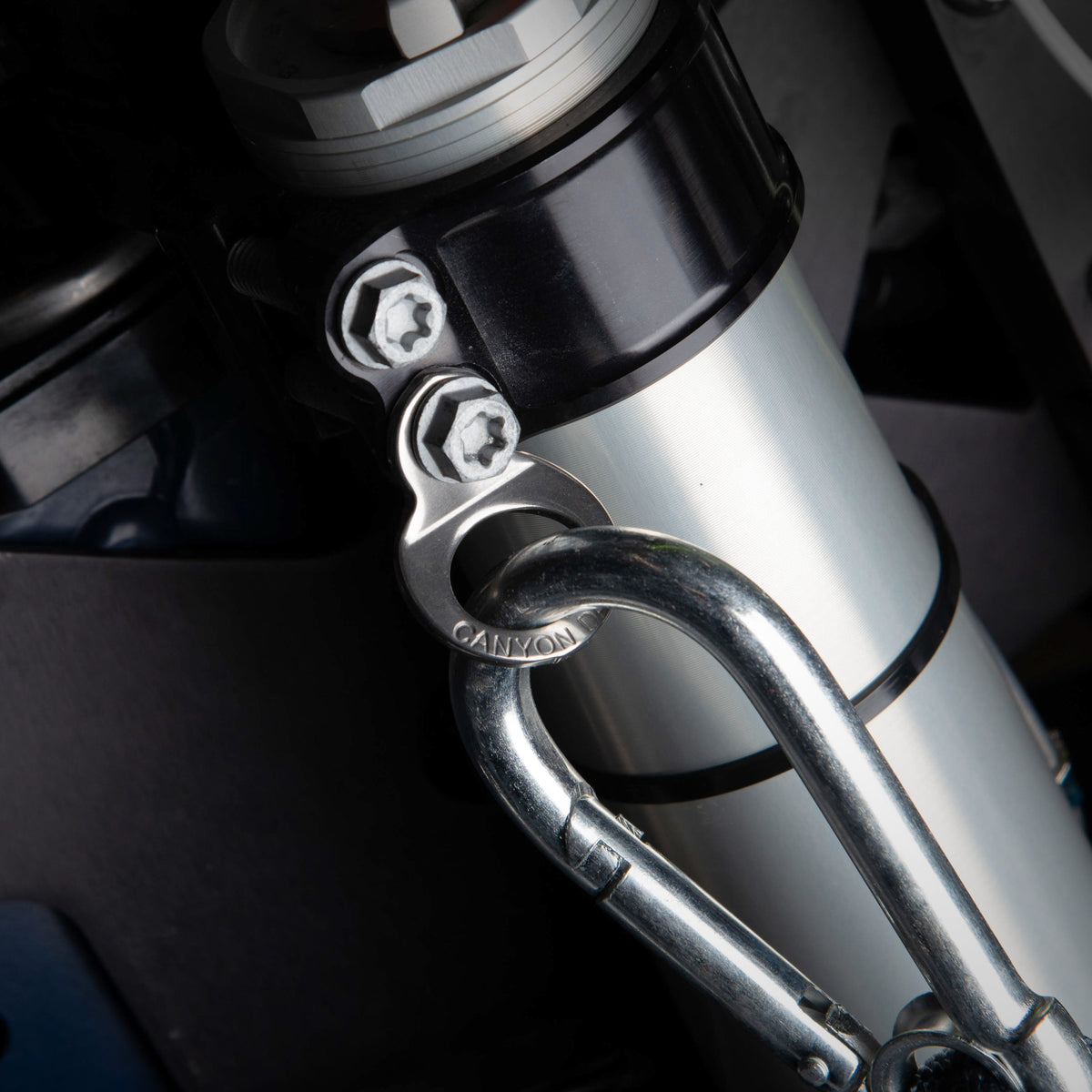 Canyon Dancer 90009 stainless steel tie down ring set showing the 10mm mounting hole and strap loop.