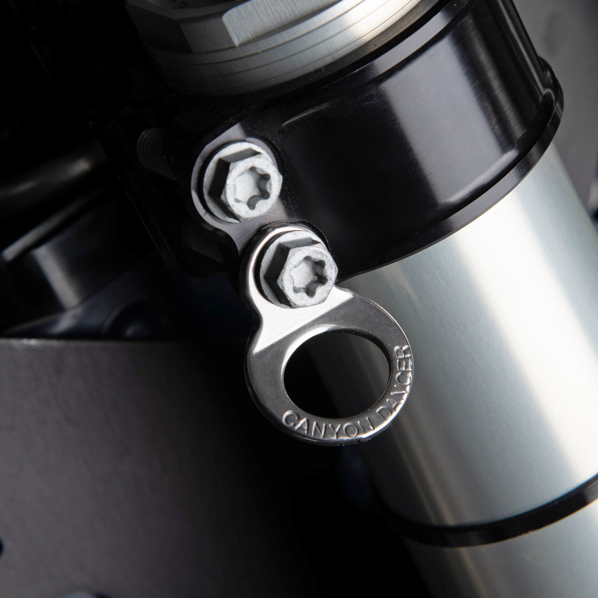 Canyon Dancer 90009 stainless steel tie down ring set showing the 10mm mounting hole and strap loop.