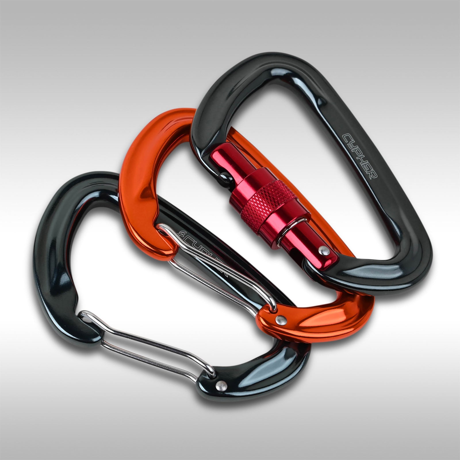 Three Cypher Firefly II carabiners with different gates, including a locking gate, a wire gate, and a screw lock gate, arranged in an overlapping fashion. The carabiners are made of metal and come in black, orange, and silver colors.