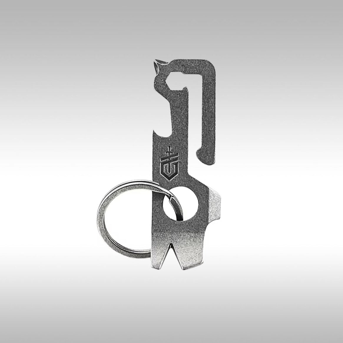 A silver Gerber Mullet keychain tool with multiple implements, including a bottle opener and drivers, displayed against a grey background.