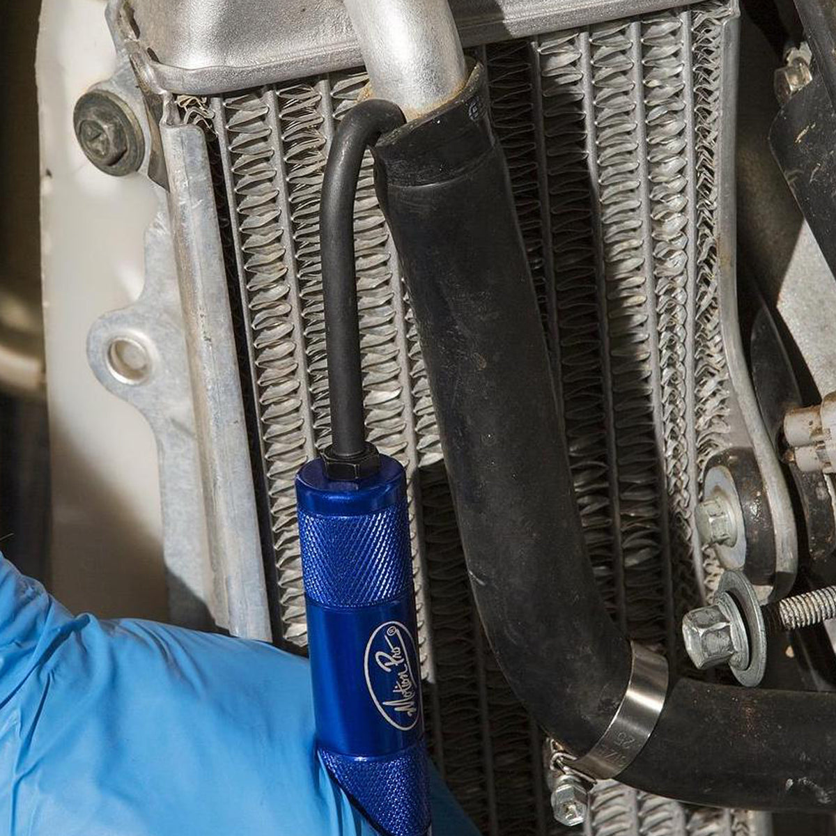 Motion Pro hose removal tool in use on a motorcycle coolant system