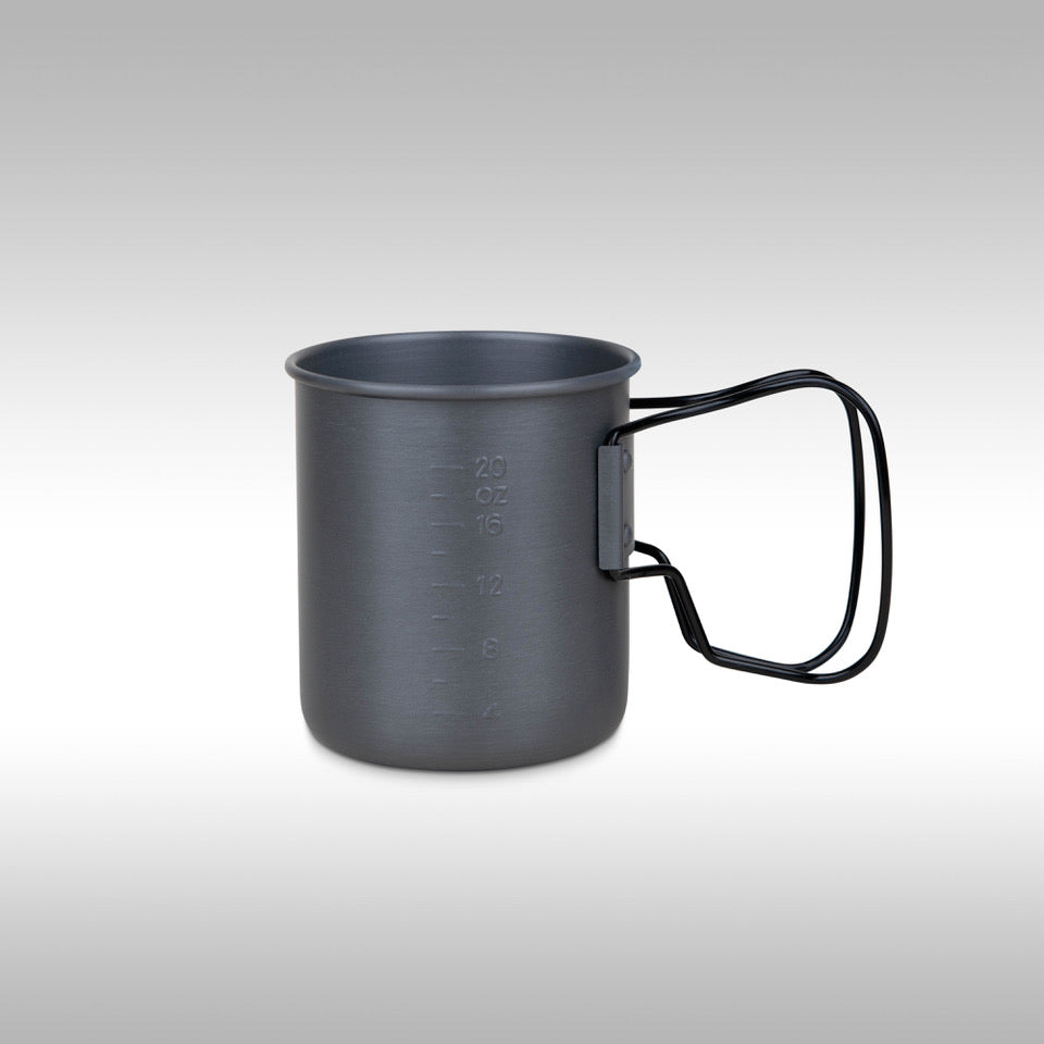 Gray metal mug with black handle on a light gray background